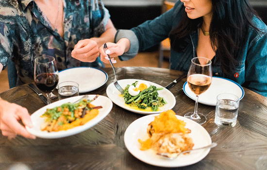 Two people sit at a table at one of Calgary's vegetarian restaurants